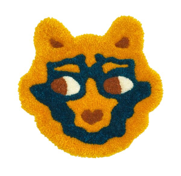 tufted forest creature mask in yellow, dark teal, and burnt orange