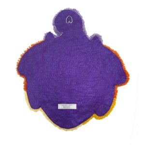 back of tufted mask with purple felt backing, a wall hook, and a label